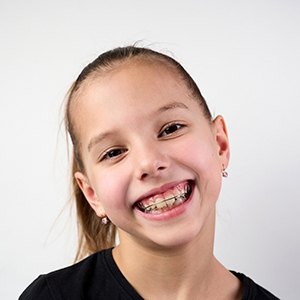 a girl with braces smiling confidently