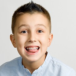 a child with braces smiling 