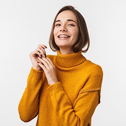 a teen with braces smiling