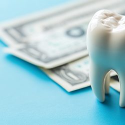 Lone tooth and various dollar bills