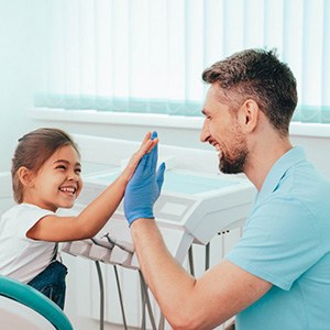 Child high-fiving her dentist